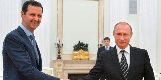 FILE - In this Tuesday, Oct. 20, 2015 file photo, Russian President Vladimir Putin, right, shakes hand with Syria President Bashar Assad in the Kremlin in Moscow, Russia. Russiaâs involvement in Syria has led to resumed talks about Syriaâs future in Vienna. So far thereâs no progress but at least there are talks, notable for including Iran, at Russiaâs insistence, for the first time. They are notable as well for easing the Kremlinâs isolation after its takeover of Crimea and backing for pro-Moscow forces fighting the central government in Ukraine. (Alexei Druzhinin, RIA-Novosti, Kremlin Pool Photo via AP, File)