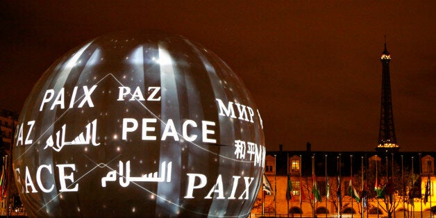 The word peace in the six official languages of the organization is projected at UNESCO headquarters in Paris, France, Saturd