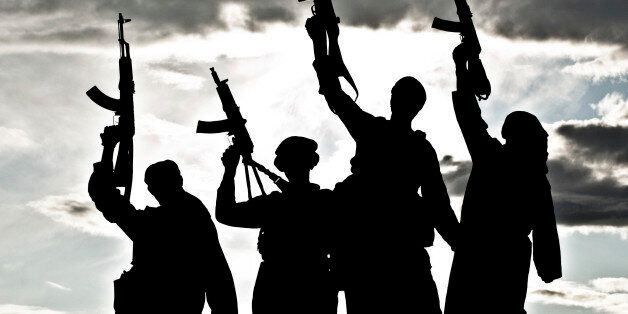 Silhouette of several muslim militants with rifles