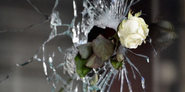 PARIS, FRANCE - NOVEMBER 15: A rose is placed beside a bullet hole at La Belle Equipe restaraunt on Rue de Charonne following Fridays terrorist attack on November 15, 2015 in Paris, France. As France observes three days of national mourning members of the public continue to pay tribute to the victims of Friday's deadly attacks. A special service for the families of the victims and survivors is to be held at Paris's Notre Dame Cathedral later on Sunday. (Photo by Jeff J Mitchell/Getty Images)