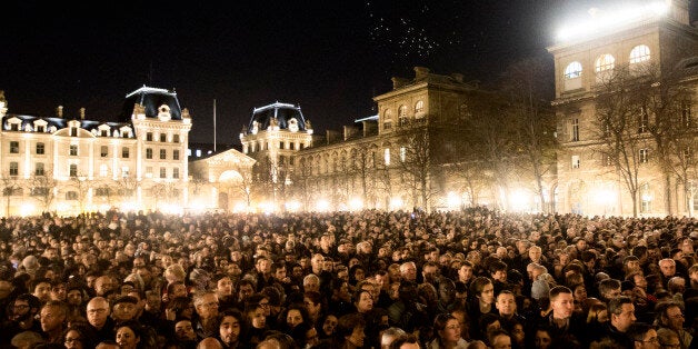 People gather for a national service for the victims of the terror attack at Notre Dame cathedral in Paris, Sunday, Nov. 15, 2015. Thousands of French troops deployed around Paris on Sunday and tourist sites stood shuttered in one of the most visited cities on Earth while investigators questioned the relatives of a suspected suicide bomber involved in the country's deadliest violence since World War II. (AP Photo/Daniel Ochoa de Olza)