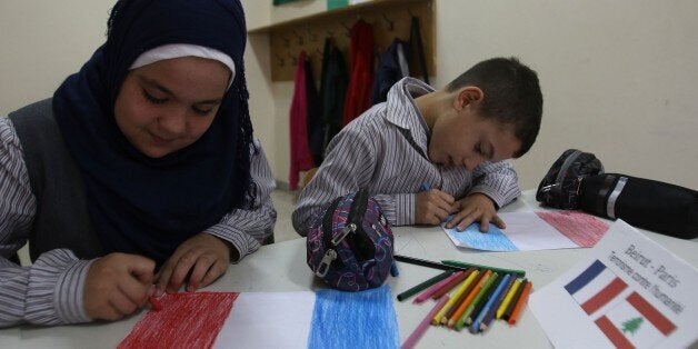 Children draw French flags at the Bahaa Al-Hariri school in the southern Lebanese city of Sidon on November 16, 2015. An event called 'Terrorism Against Humanity' was organised by the establishement in order to encourage discussion between students and teachers and to express solidarity with the victims of last week's Paris and Beirut attacks, both claimed by the extremist Islamic State (IS) jihadist group. AFP PHOTO / MAHMOUD ZAYYAT (Photo credit should read MAHMOUD ZAYYAT/AFP/Getty Images)