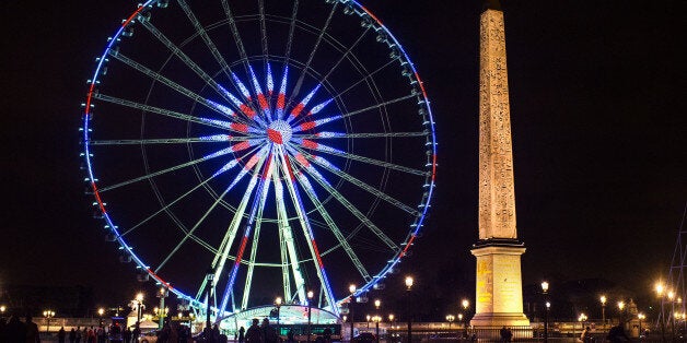 PARIS, FRANCE - NOVEMBER 16: The Roue de Paris is illuminated in Red, White and Blue in honor of the victims of Friday's terrorist attacks on November 16, 2015 in Paris, France. Countries across Europe joined France today to observe a one minute-silence in an expression of solidarity with the victims of the terrorist attacks, which left at least 129 people dead and hundreds more injured. (Photo by David Ramos/Getty Images)