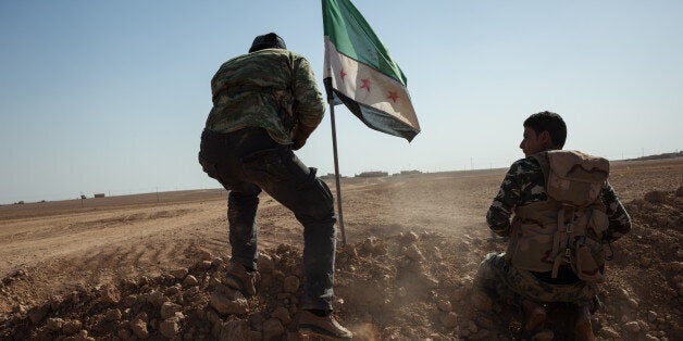 RAQQA COUNTRYSIDE, OCTOBER 17: Members of the Syrian armed group Liwa Thuwar al-Raqqa hold positions in the frontline against the Islamic State group outside Ayn al-Issa, in the countryside of Raqqa province.