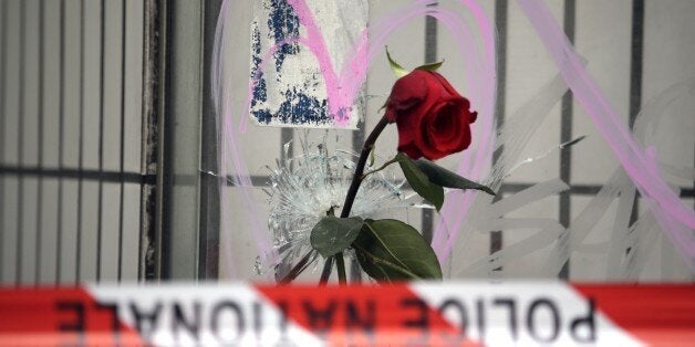 Flowers are put on bullet holes in the windows of the cafe 'Bonne biere', on November 17, 2015 in tribute to the victims of the Paris attacks claimed by Islamic State which killed at least 129 people and left more than 350 injured on November 13. AFP PHOTO / KENZO TRIBOUILLARD (Photo credit should read KENZO TRIBOUILLARD/AFP/Getty Images)