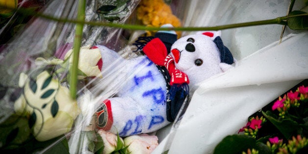 PARIS, FRANCE - NOVEMBER 17: Tributes and flowers are left near the 'Bataclan' concert hall on November 17, 2015 in Paris, France.Paris remains under heightened security following terrorist attacks , which left at least 129 people dead and hundreds more injured. (Photo by Marc Piasecki/Getty Images)