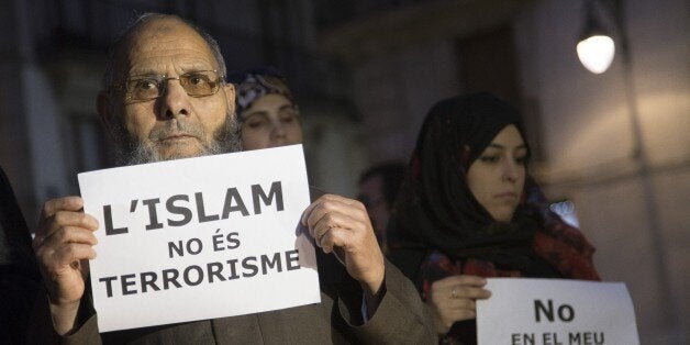 BARCELONA, SPAIN - NOVEMBER 16: Muslims from Barcelona gather to condemn Friday terror attacks in Paris by holding posters at Placa Sant Jaume in Barcelona, Spain on November 16, 2015. (Photo by Albert Llop/Anadolu Agency/Getty Images)