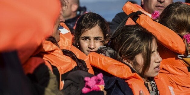 Migrants and refugees arrive on the Greek island of Lesbos after crossing the Aegean Sea from Turkey on November 18, 2015. Lesbos and other Greek Aegean islands are at the forefront of the greatest migration challenge facing the European Union since World War II. Over 600,000 migrants and refugees, mostly from war-torn Syria, have landed in Greece this year, but nearly 500 have died in the Aegean. AFP PHOTO / BULENT KILIC (Photo credit should read BULENT KILIC/AFP/Getty Images)