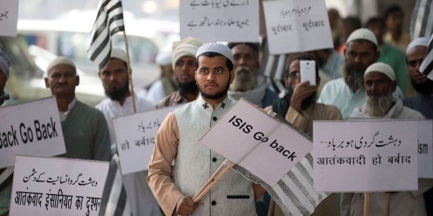 Indian Muslims hold banners and participate in a protest against ISIS, an Islamic State group, and Friday's Paris attacks, in New Delhi, India, Wednesday, Nov. 18, 2015. Multiple attacks across Paris on Friday night have left more than one hundred dead and many more injured. Placards read, bottom left, "Terrorism a threat to humanity", bottom right, "Terrorism should end". (AP Photo/Manish Swarup)