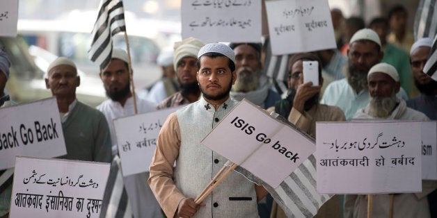 Indian Muslims hold banners and participate in a protest against ISIS, an Islamic State group, and Friday's Paris attacks, in