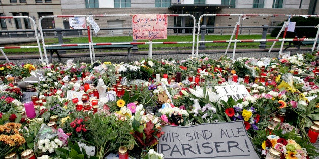 Flowers are placed in front of the embassy of France close to the Brandenburg Gate in Berlin, Germany, Monday, Nov. 16, 2015,