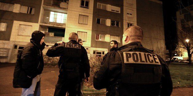 Police officers enforce a curfew at a housing project of the Champs Plaisants district of Sens, southeast of Paris, on November 20, 2015, where for the first time since the announcement of a state of emergency, a curfew was declared today for the duration of the weekend, following the discovery of weapons and false documents during administrative searches conducted by police earlier in the day. Gunmen and suicide bombers went on a killing spree in Paris on November 13, attacking the concert hall Bataclan as well as bars, restaurants and the Stade de France. Islamic State jihadists operating out of Iraq and Syria released a statement claiming responsibility for the coordinated attacks that killed 130 and injured over 350. AFP PHOTO / FRANCOIS NASCIMBENI (Photo credit should read FRANCOIS NASCIMBENI/AFP/Getty Images)