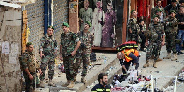 BAIRUT, LEBANON - NOVEMBER 13: Lebanese soldiers inspect an area where two explosions took place at Dahieh, know as Hezbollah stronghold, South Beirut, Lebanon on November 13, 2015. At least 35 people were killed and another 180 injured by double bombings. (Photo by Ratib Al Safadi/Anadolu Agency/Getty Images)