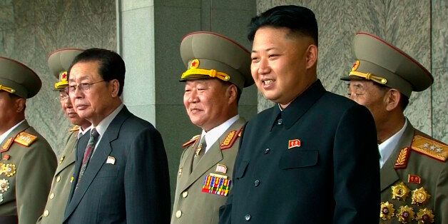In this image taken from video North Korean leader Kim Jong Un, second from right, smiles while watching a military parade marking the 65th anniversary of the country's founding, Monday, Sept. 9, 2013, in Pyongyang, North Korea. (AP Photo/KRT via AP Video) TV OUT, NORTH KOREA OUT