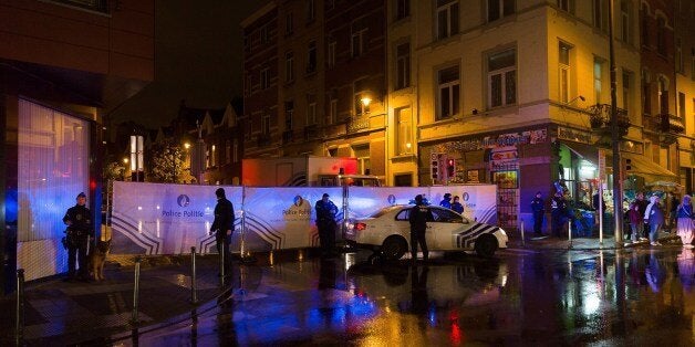 Belgian police cordon off a street during a police raid in connection with the November 13 deadly attacks in Paris, in Brusse