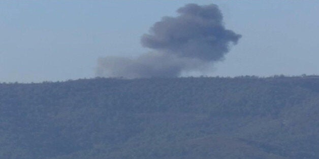 This frame grab from video by Haberturk TV, shows smoke from a Russian warplane after crashing on a hill as seen from Hatay p