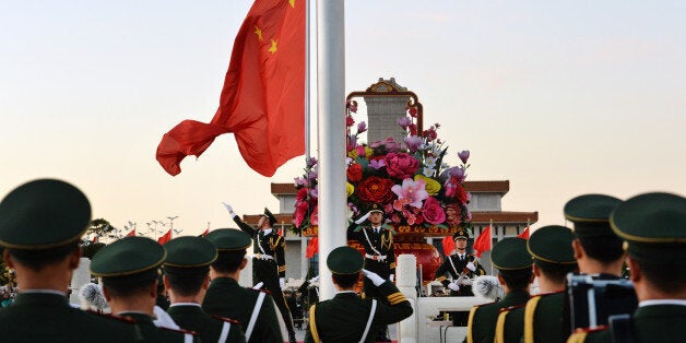 BEIJING, CHINA - OCTOBER 01: (CHINA OUT) Flag-bearers walk toward the platform to raise the Chinese national flag in the morn