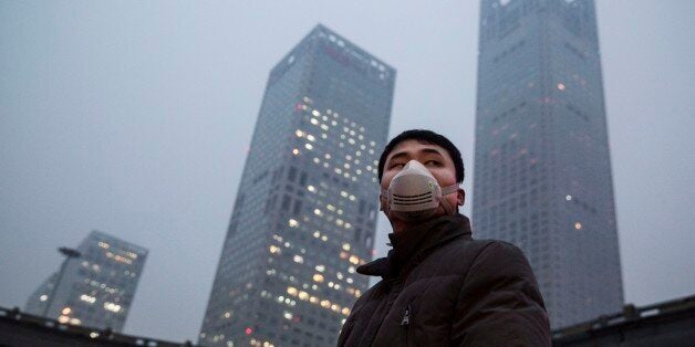 BEIJING, CHINA - DECEMBER 08: A Chinese man wears a mask to protect against pollution in heavy smog on December 8, 2015 in Beijing, China. The Beijing government issued a 'red alert' for the first time since new standards were introduced earlier this year as the city and many parts of northern China were shrouded in heavy pollution. Levels of PM 2.5, considered the most hazardous, crossed 400 units in Beijing, lower than last week, but still nearly 20 times the acceptable standard set by the World Health Organization. The governments of more than 190 countries are meeting in Paris to set targets on reducing carbon emissions in an attempt to forge a new global agreement on climate change. (Photo by Kevin Frayer/Getty Images)