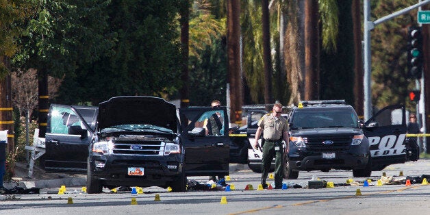 SAN BERNARDINO, CA - DECEMBER 3: Law enforcement personnel continue to investigate on San Bernardino Avenue, where two suspects in the mass shooting at the Inland Regional Center died in a shootout with police December 3, 2015 in San Bernardino, California. Investigators are looking for a motive as to why Syed Rizwan Farook and Tashfeen Malik went on a shooting rampage that left 14 dead and 17 others wounded. (Photo by Gina Ferazzi/Los Angeles Times via Getty Images)