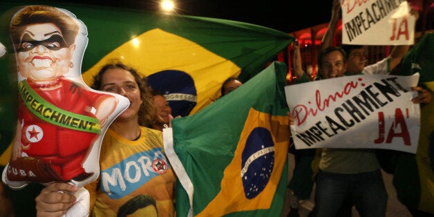 People demonstrate against the government as they take part in protest in favor of the impeachment of Brazil's President Dilma Rousseff, in front of the National Congress, in Brasilia, Brazil, Wednesday, Dec. 2, 2015. Impeachment proceedings were opened Wednesday against Brazilian President Rousseff by the speaker of the lower house of Congress, a sworn enemy of the beleaguered leader. (AP Photo/Eraldo Peres)