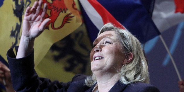 French far-right party leader Marine Le Pen gestures at the end of her meeting in Lille, northern France, Monday, Nov. 30, 2015. France is voting in regional elections Sunday for the first round in which the far right National Front is hoping to increase its political power. The second round of the regional elections will take place on Dec. 13, 2015. (AP Photo/Michel Spingler)