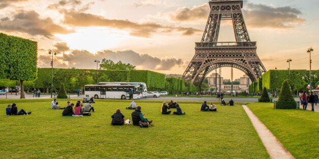Tourists relaxing in park near Eiffel Tower, Paris, France