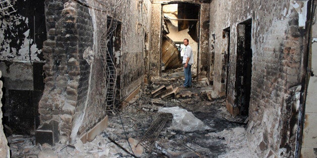 FILE - In this Oct. 16, 2015, file photo, an employee of Doctors Without Borders stands inside the charred remains of their hospital after it was hit by a U.S. airstrike in Kunduz, Afghanistan. A dozen survivors interviewed by The Associated Press are convinced that the attack on the hospital, which treated wounded Taliban and government fighters alike, was no accident. They say it was sustained and focused on destroying the main hospital building, which the aid agency says âcorrelates exactlyâ with GPS coordinates it had given to all parties in the conflict. (Najim Rahim via AP, File)