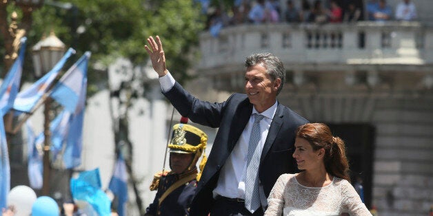 BUENOS AIRES, ARGENTINA - DECEMBER 10: President of Argentina Mauricio Macri and his wife Juliana Awada greet the crowdd as they head for Casa Rosada after the swearing in ceremony on December 10, 2015 in Buenos Aires, Argentina. (Photo by Mariano Martino/LatinContent/Getty Images)