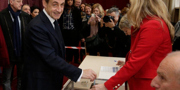 Nicolas Sarkozy, former French President and current head of the conservative "Les Republicains" party, casts his ballot in the second-round regional elections in Paris, Sunday, Dec. 13, 2015. Marine Le Pen's anti-immigration National Front was the frontrunner heading into the decisive second round of French regional elections Sunday, and now it's up to voters whether to hand the once-pariah party an unprecedented political victory. (Philippe Wojazer/Pool Photo via AP)