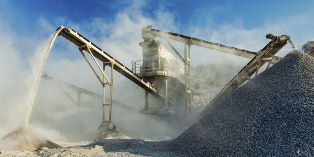 Industrial background - crusher rock stone crushing machine at open pit mining and processing plant for crushed stone, sand and gravel