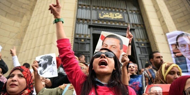 Supporters of Egypt's former president Hosni Mubark (portraits) shout slogans praising the ousted leader outside the appeals court in Cairo on November 05, 2015, as the court opened the retrial of the veteran strongman on charges of orchestrating the murders of protesters during the 2011 Arab Spring uprising that toppled him. AFP PHOTO /MOHAMED EL-SHAHED (Photo credit should read MOHAMED EL-SHAHED/AFP/Getty Images)