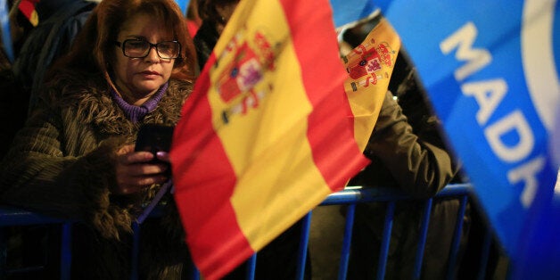 People's Party (Partido Popular) supporters wait for the results during the Spanish general election outside the party's headquarters in Madrid, Spain, on Sunday, Dec. 20, 2015. Spaniards are voting in the tightest election since the country's return to democracy, with four parties in the running and no clear winner in sight. Photographer: Pau Barrena/Bloomberg via Getty Images