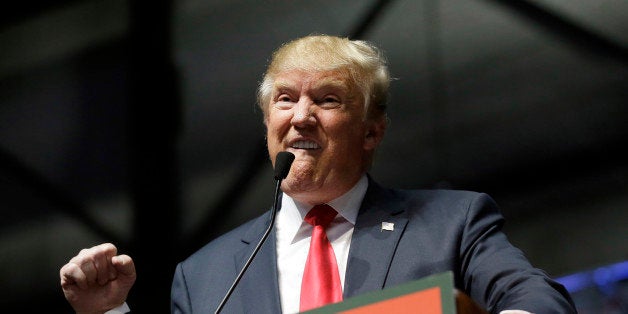 Republican presidential candidate, businessman Donald Trump addresses supporters at a campaign rally, Monday, Dec. 21, 2015, in Grand Rapids, Mich. (AP Photo/Carlos Osorio)