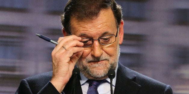 Spanish incumbent Prime Minister Mariano Rajoy (C) touches his glasses during a press conference after the national executive meeting of the Popular Party in Madrid on December 21, 2015. Spain's Prime Minister Mariano Rajoy faced an uphill battle to stay in power on Monday after his conservatives lost their majority in an election that saw dynamic new political groupings end decades of two-party rule. AFP PHOTO/ CESAR MANSO / AFP / CESAR MANSO (Photo credit should read CESAR MANSO/AFP/Getty Images)