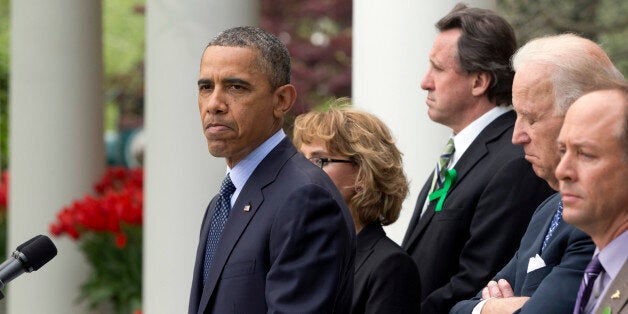 President Barack Obama frowns as he speaks during a news conference in the Rose Garden of the White House, in Washington, on Wednesday, April 17, 2013, about a bill to expand background checks on guns that was defeated in the Senate. He is joined by former Rep. Gabby Giffords, second from left, Vice President Joe Biden, and Newtown family members from left, Neil Heslin, father of Jesse Lewis; and Mark Barden. (AP Photo/Jacquelyn Martin)