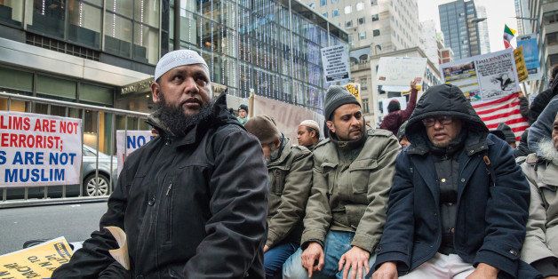 MIDTOWN MANHATTAN, NEW YORK, UNITED STATES - 2015/12/20: Muslim-American men from a local mosque pray in front of Trump Tower. Several hundred demonstrators rallied outside of Trump Tower at East 56th Street and Fifth Avenue in Manhattan to condemn Republican Presidential candidate Donald Trump's position on immigration rights; after rallying for nearly two hours, demonstrators marched to Herald Square. (Photo by Albin Lohr-Jones/Pacific Press/LightRocket via Getty Images)