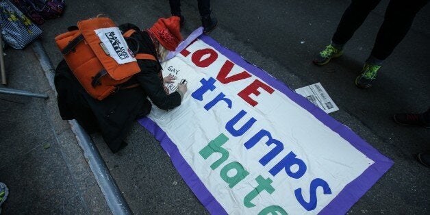 NEW YORK, UNITED STATES - DECEMBER 20: People, including members of Muslim community and the others from varied religions and beliefs, stage a protest against hate speech of US Republican presidential candidate Donald Trump, during a march started in front of the Trump Tower at 5th Avenue towards CNN and FOX TV buildings in New York City, USA on December 20, 2015. US Republican presidential candidate Donald Trump wants 'total and complete shutdown of Muslims entering the United States' as well as he said 'All Muslim immigration to the United States should be halted' (Photo by Cem Ozdel/Anadolu Agency/Getty Images)