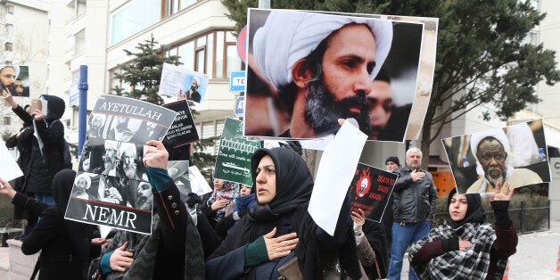 Iranian and Turkish demonstrators hold pictures of Shiite cleric Sheikh Nimr al-Nimr as they protest outside the Saudi Embassy in Ankara, on January 3, 2016, to protest against the execution by Saudi Arabia of a prominent Shiite cleric which they saw as a deliberate sectarian aggression.Nimr and other Shiite activists were among a total of 47 people executed, most of them described by the interior ministry as involved in killings by Al-Qaeda. / AFP / ADEM ALTAN (Photo credit should read ADEM ALTAN/AFP/Getty Images)