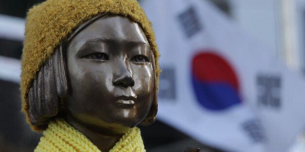 SEOUL, SOUTH KOREA - DECEMBER 28: A statue of a girl symbolizing the issue of 'comfort women' in front of the Japanese Embassy on December 28, 2015 in Seoul, South Korea. South Korean Foreign Minister Yun Byung Se and Japanese Foreign Minister Fumio Kishida met to discuss the issue of Korean 'comfort women' in Japanese military brothels before and during World War II. (Photo by Chung Sung-Jun/Getty Images)
