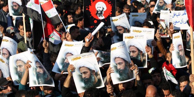 Supporters of Iraqi Shiite cleric Moqtada al-Sadr hold posters of prominent Shiite cleric Nimr al-Nimr during a demonstration in the capital Baghdad on January 4, 2016, against Nimr's execution by Saudi authorities. Sunni-ruled Saudi Arabia severed diplomatic ties with Shiite-dominated Iran, its long-time regional rival, after angry demonstrators attacked the Saudi embassy in Tehran and its consulate following Nimr's execution. AFP PHOTO / AHMAD AL-RUBAYE / AFP / AHMAD AL-RUBAYE (Photo credit should read AHMAD AL-RUBAYE/AFP/Getty Images)