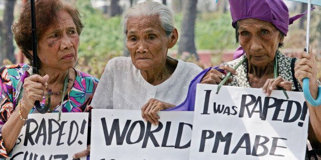 Alleged Filipino "comfort women" or sex slaves display placards during a rally at the Japanese Embassy in Manila, Philippines on Tuesday March 6, 2007. Nearly two dozen elderly Filipino women called Japan's prime minister "a liar" on Tuesday after he said there was no evidence that women were forced into front-line brothels by Japanese troops during World War II. (AP Photo/Bullit Marquez)