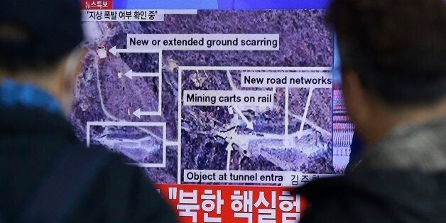 People watch a TV screen showing the news reporting about an earthquake near North Korea's nuclear facility at the Seoul Rail