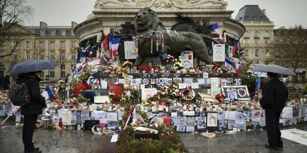 TOPSHOT - A picture taken on January 7, 2016 shows a makeshift memorial for the victims of Paris attacks at the Place de la Republique in Paris, as France holds official ceremonies marking a year since a jihadist attack on the offices of Charlie Hebdo, with the French satirical magazine defiantly reasserting its provocative spirit. / AFP / ERIC FEFERBERG (Photo credit should read ERIC FEFERBERG/AFP/Getty Images)