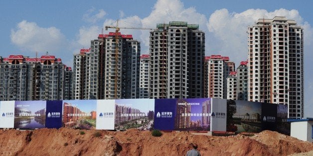 Empty apartment developments stand in the city of Ordos, Inner Mongolia on September 12, 2011. The city which is commonly referred to as a 'Ghost Town' due to it's lack of people, is being built to house 1.5 million inhabitants and has been dubbed as the 'Dubai of China' by locals. AFP PHOTO/Mark RALSTON (Photo credit should read MARK RALSTON/AFP/Getty Images)