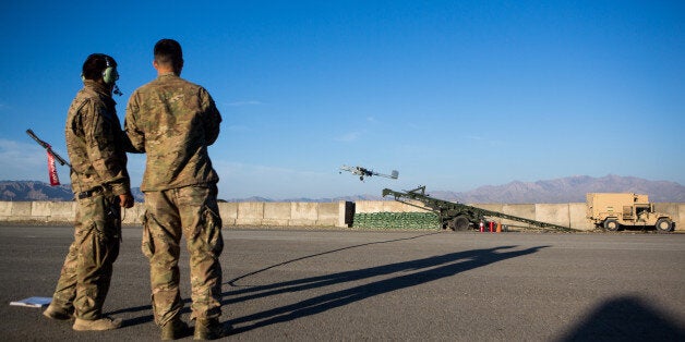 FOB SHANK, LOGAR PROVINCE - MAY 8: Two U.S. Army soldiers launch a 14' Shadow Unmanned Aerial Vehicle, or UAV, from an airstr