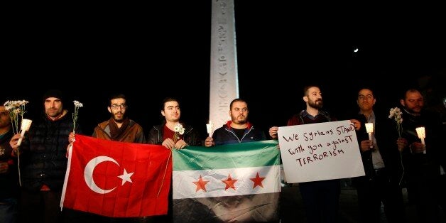 People attend a vigil at the site of Tuesday's explosion, in the historic Sultanahmet district of Istanbul, Wednesday, Jan. 13, 2016. A suicide bomber detonated a bomb in the heart of Istanbul's historic district on Tuesday, killing 10 foreigners and wounding 15 other people in the latest in a string of attacks by the Islamic extremists targeting Westerners. (AP Photo/Emrah Gurel)