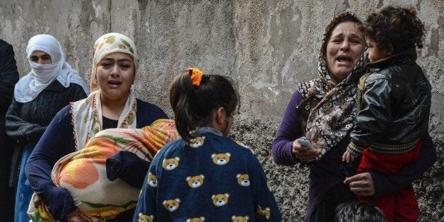 Women react after a mortar hit a house during clashes with Turkish police at the Sur district in Diyarbakir, southeastern Turkey, on January 3, 2016. Tensions are running high throughout Turkey's restive southeast as security forces impose curfews in several towns including Cizre in a bid to root out Kurdistan Workers' Party (PKK) rebels from urban centres. / AFP / ILYAS AKENGIN (Photo credit should read ILYAS AKENGIN/AFP/Getty Images)