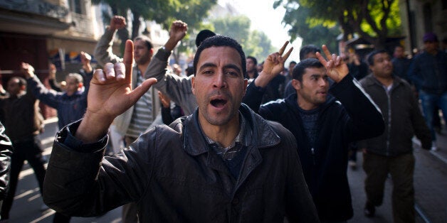 People demonstrate during a protest in central Tunis on January 17, 2011. Tunisian protesters called for the abolition of ousted president Zine El Abidine Ben Ali's ruling party on January 17 amid a chaotic power vacuum as politicians prepared a government of national unity. Hundreds of people rallied in Tunis and there were similar protests in Sidi Bouzid and Regueb in central Tunisia -- two towns at the heart of the movement that forced Ben Ali to resign and flee on Friday after 23 years in power. on January 17, 2011 in the center of Tunis. AFP PHOTO / MARTIN BUREAU (Photo credit should read MARTIN BUREAU/AFP/Getty Images)