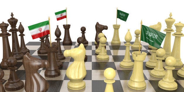 Foreign policy strategy concept of a chess board with rooks carrying national flags for Iran and Saudi Arabia.