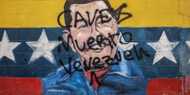 Picture of a graffiti depicting late Venezuelan President (1999-2013) Hugo Chavez, taken in Caracas on November 2, 2015. A